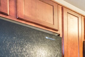 Stone Garden on Birch kitchen area with appliances, cabinets, and counters